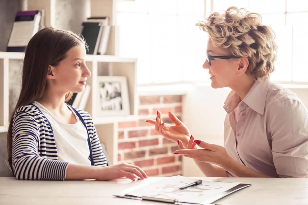 Teen and counselor working on depression in adolescents
