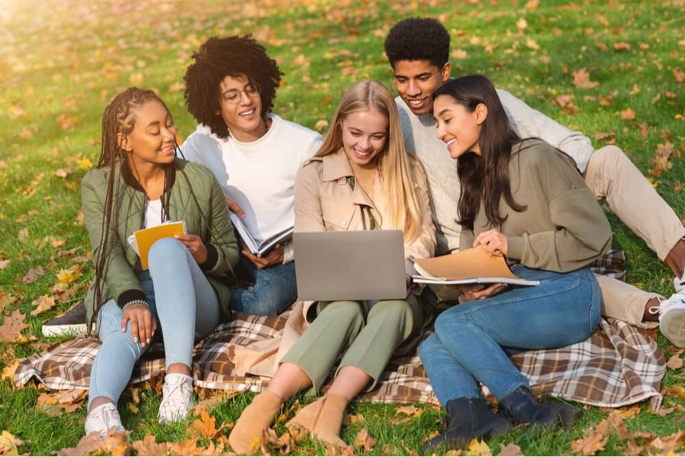 group of students studying at public park