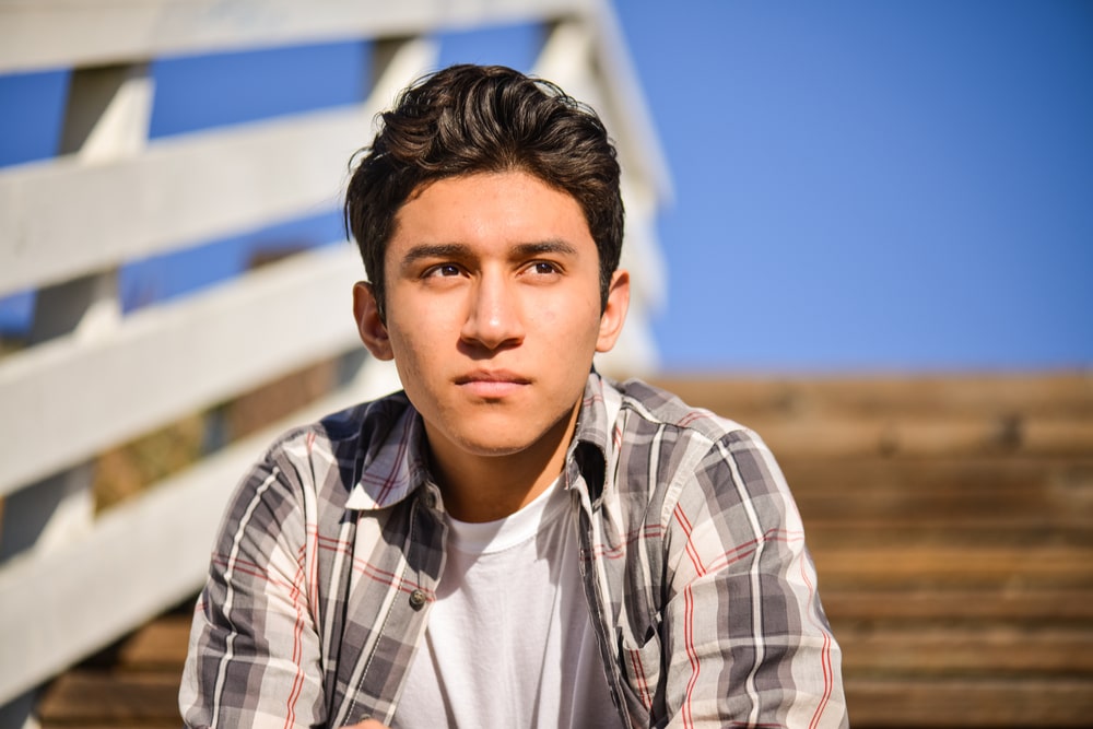 Young man outside sitting on steps